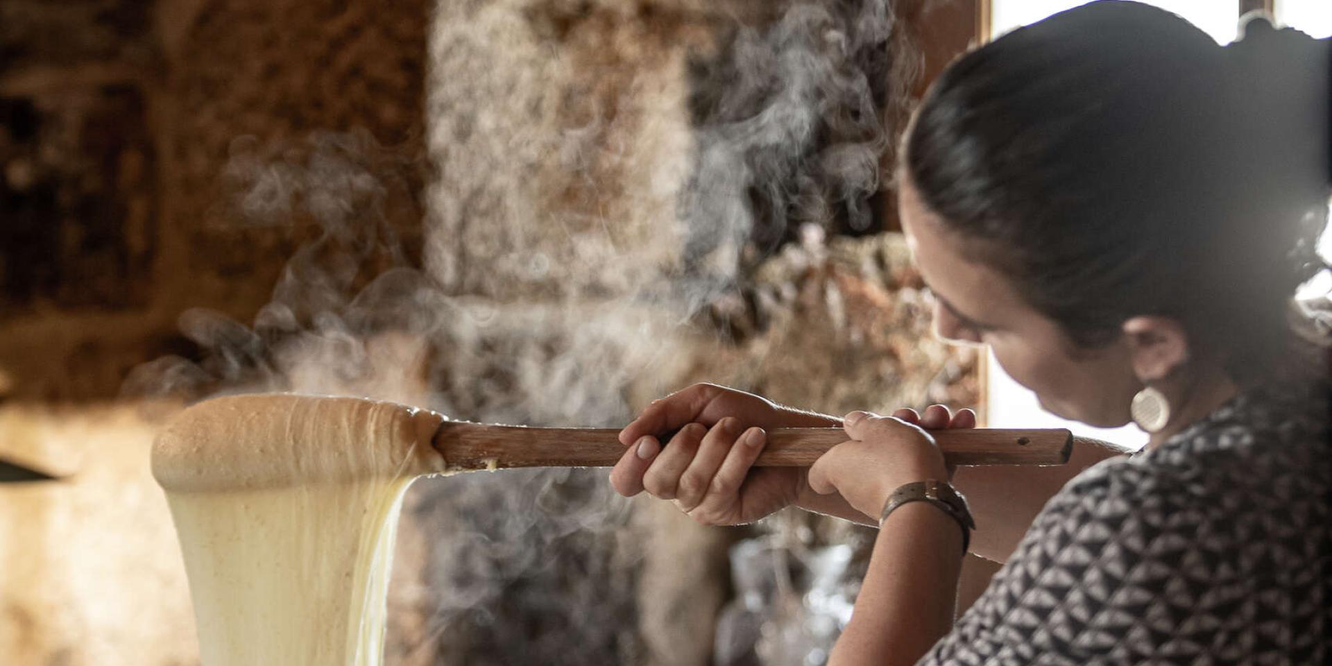 Woman preparing aligot in an Aubrac buron.